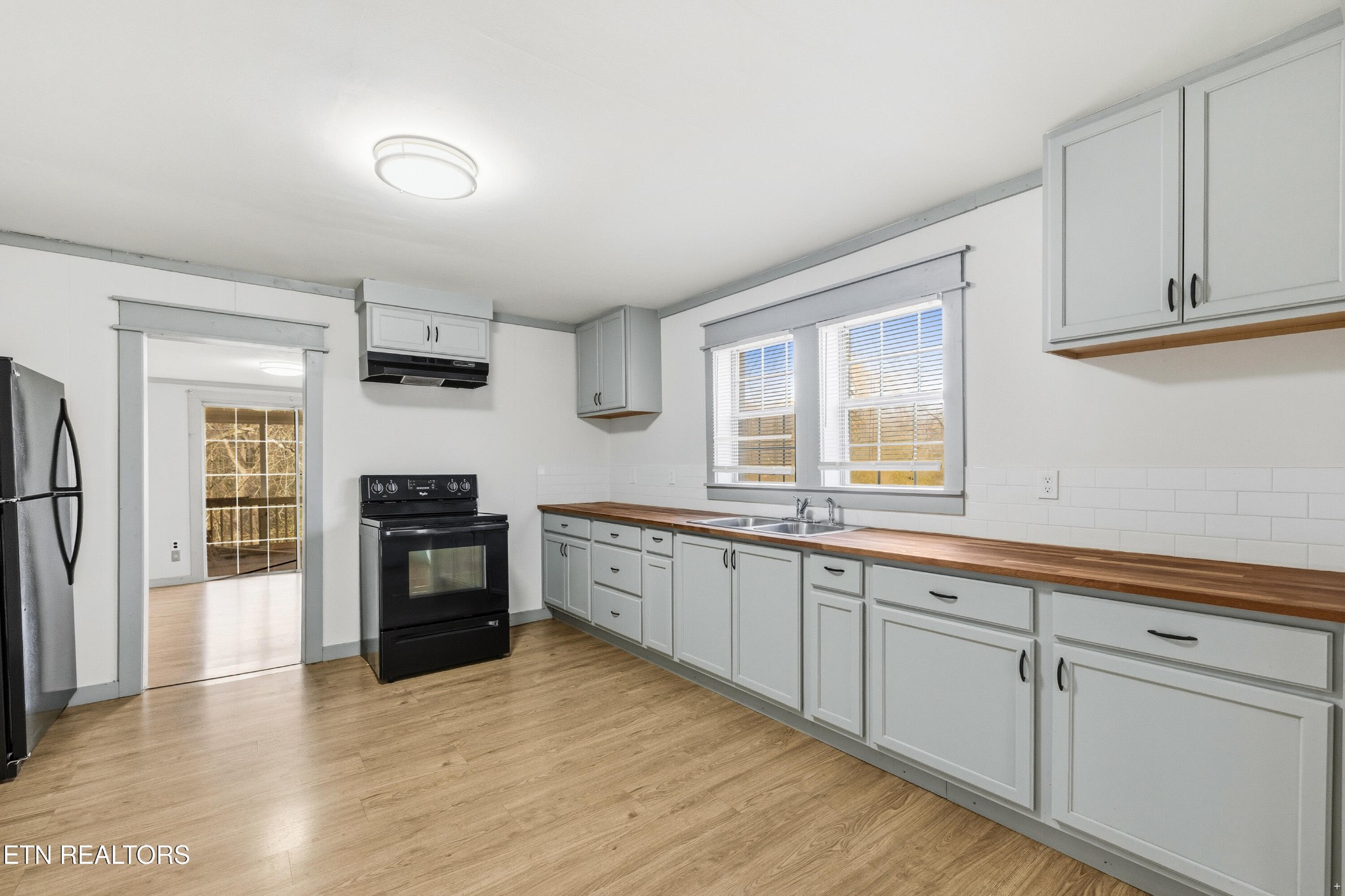 2438 Southside Road Knoxville, TN 37920 - Photo 7 of 21 a kitchen with granite countertop a refrigerator stove top oven and sink