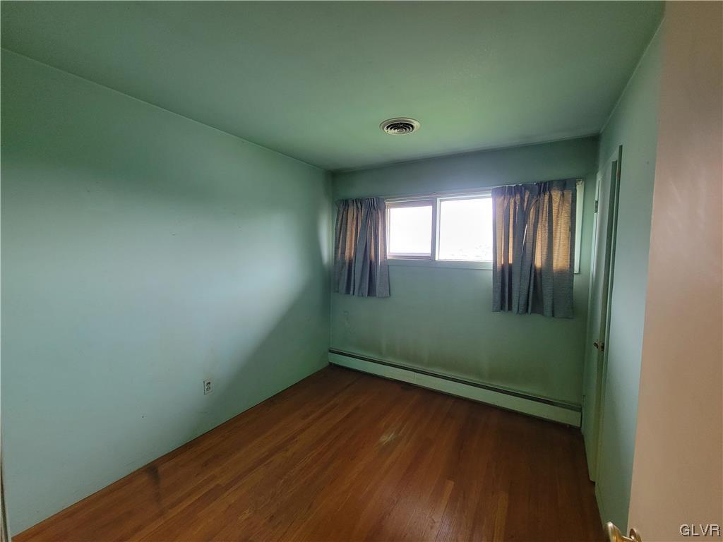 1312 5th Street Whitehall, PA 18052 - Photo 11 of 29 an empty room with wooden floor and windows