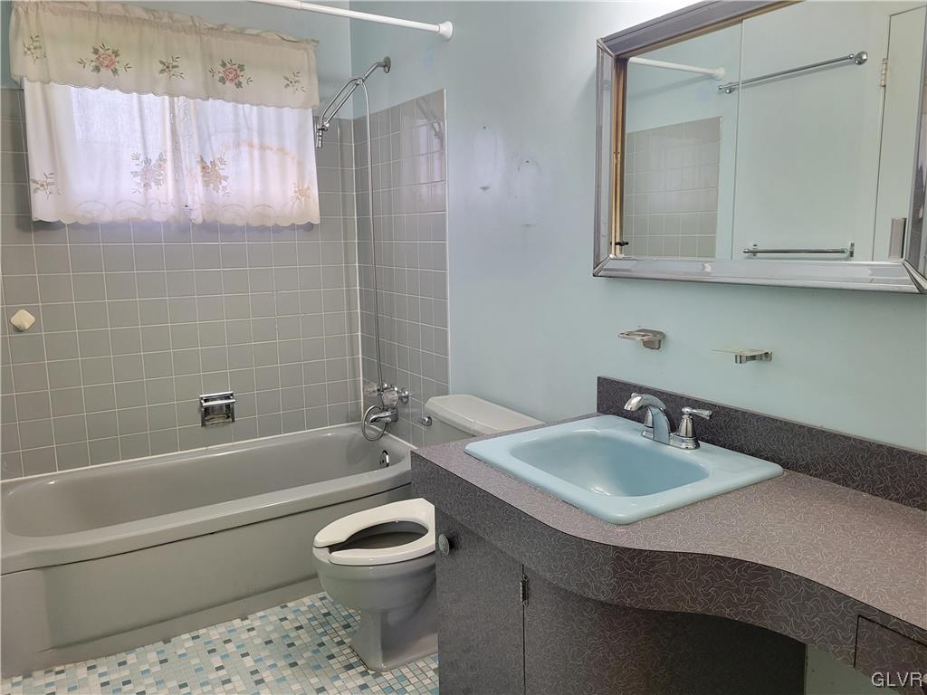 1312 5th Street Whitehall, PA 18052 - Photo 14 of 29 a bathroom with a sink a toilet and bathtub