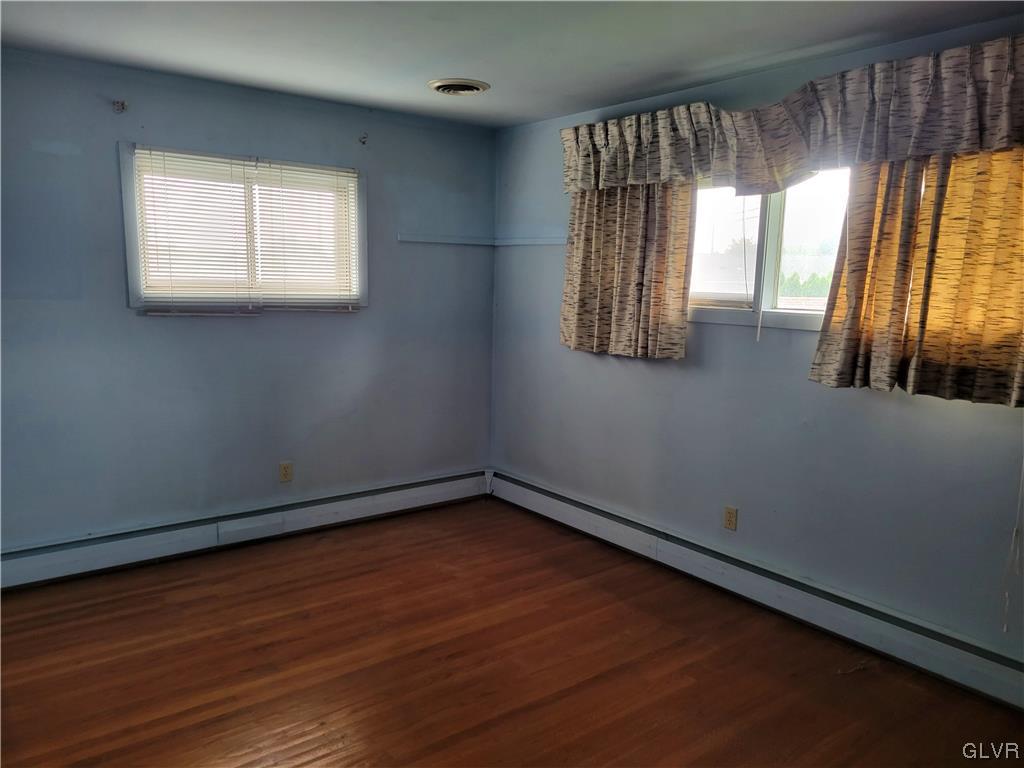 1312 5th Street Whitehall, PA 18052 - Photo 15 of 29 an empty room with wooden floor and windows