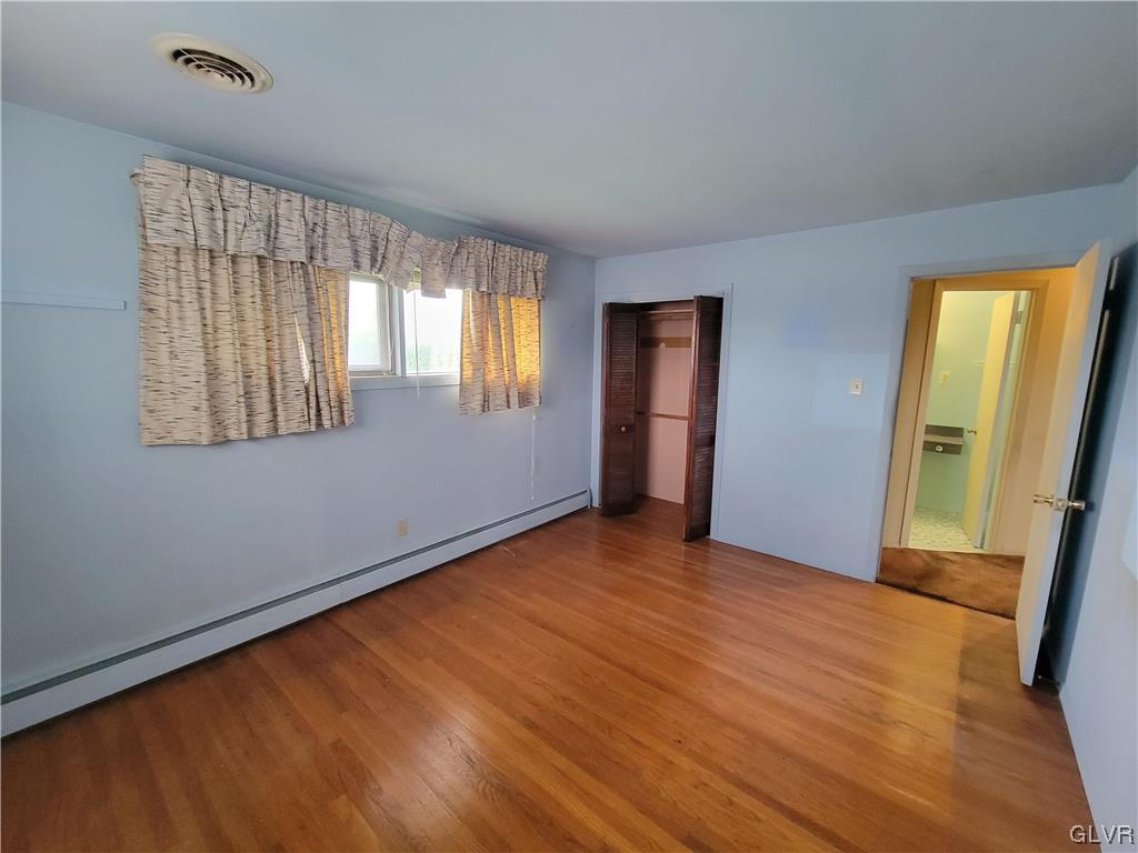 1312 5th Street Whitehall, PA 18052 - Photo 17 of 29 a view of an empty room with wooden floor and a window