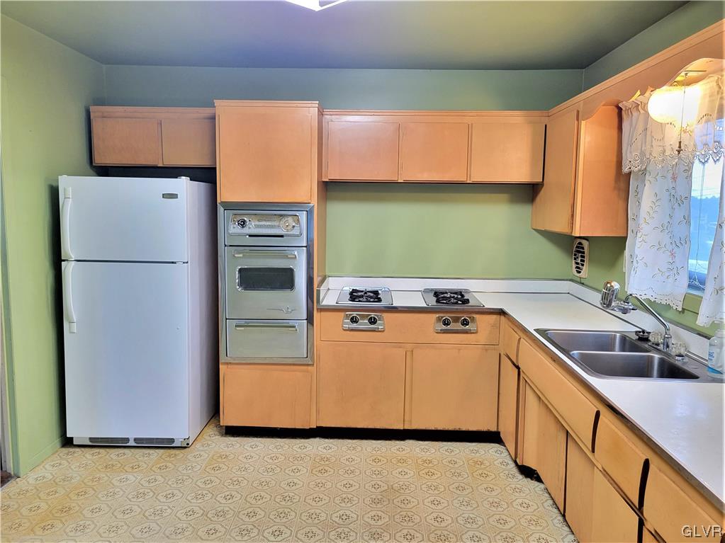 1312 5th Street Whitehall, PA 18052 - Photo 2 of 29 a kitchen with a refrigerator sink and cabinets