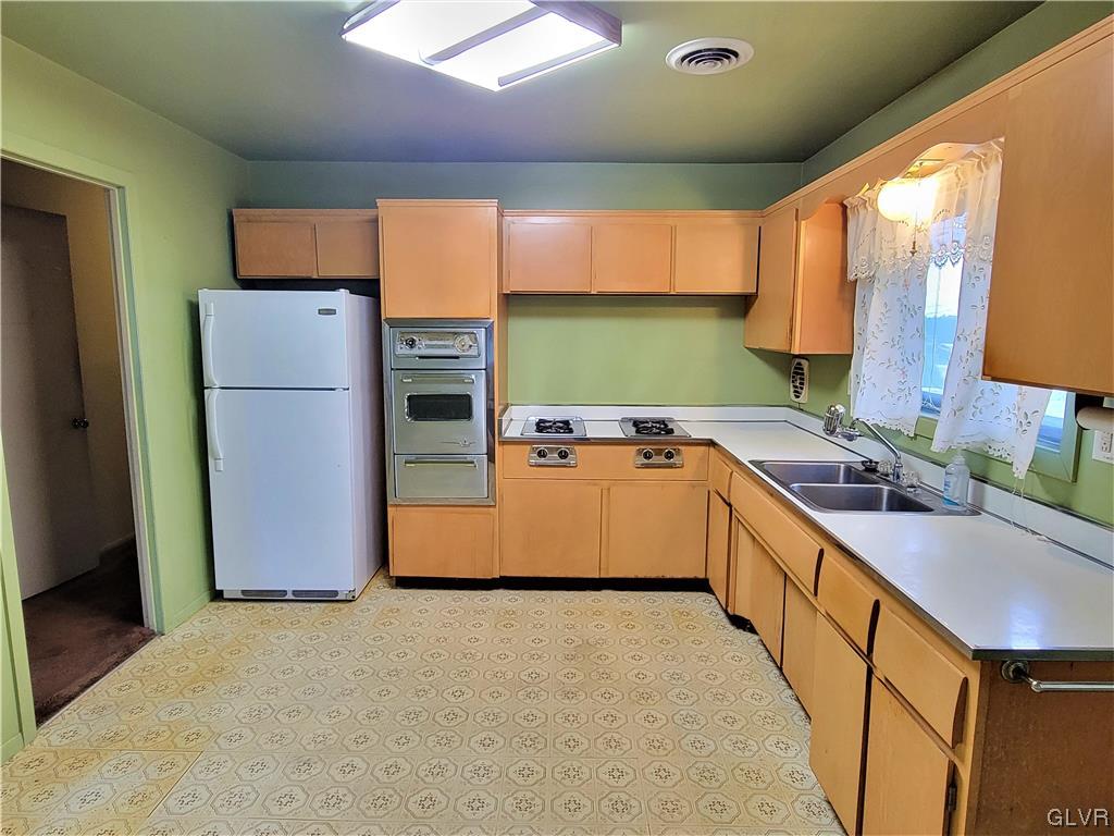 1312 5th Street Whitehall, PA 18052 - Photo 3 of 29 a kitchen with stainless steel appliances granite countertop a refrigerator a sink dishwasher and a stove