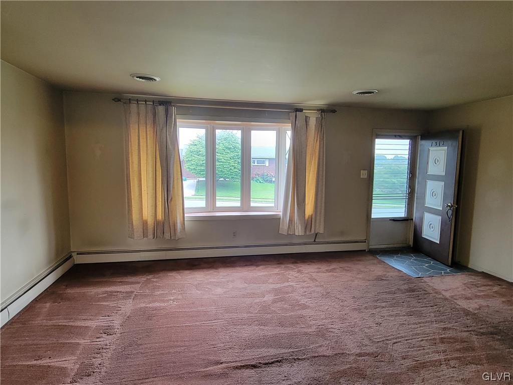 1312 5th Street Whitehall, PA 18052 - Photo 6 of 29 a view of an empty room with wooden floor and a window