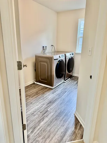 a view of a bedroom with wooden floor