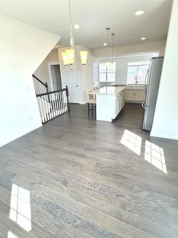 a view of a living room a dining room wooden floor and a window