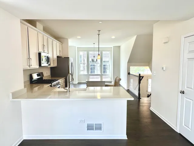 a kitchen with a refrigerator a sink and a stove