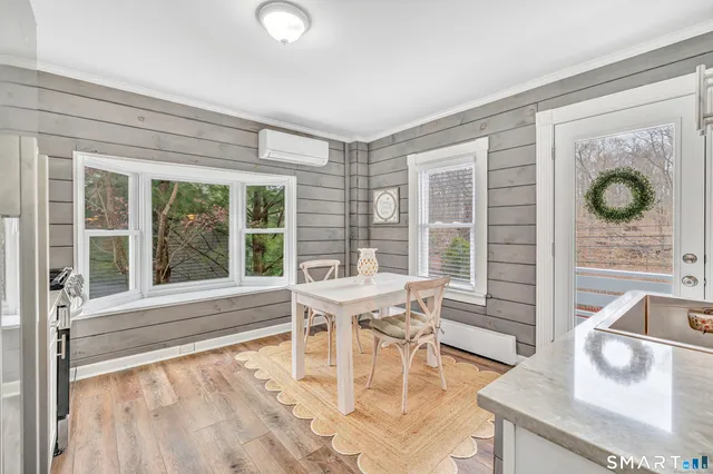 a dining room with furniture and large windows