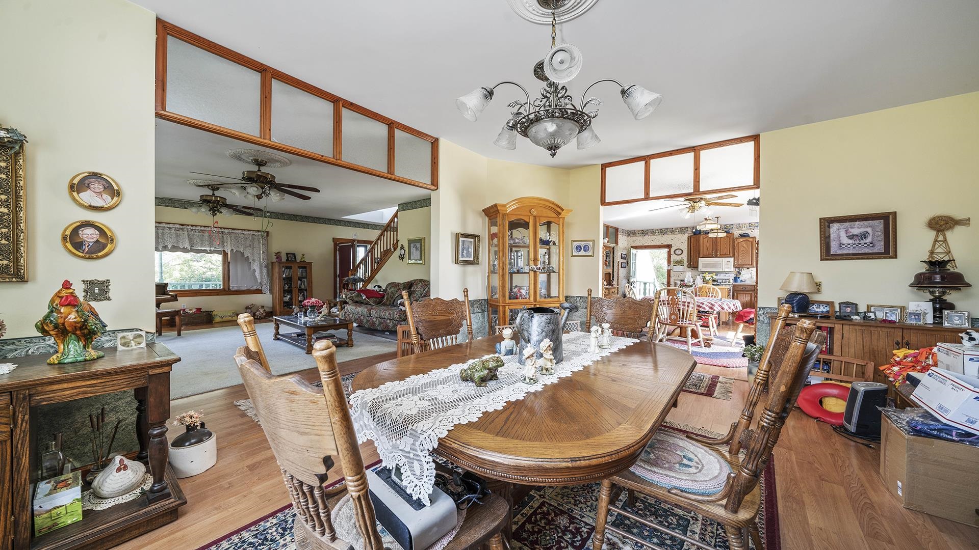 1919 Quail Trap Road Caledonia, IL 61011 - Photo 9 of 44 a view of a dining room with furniture a chandelier and wooden floor