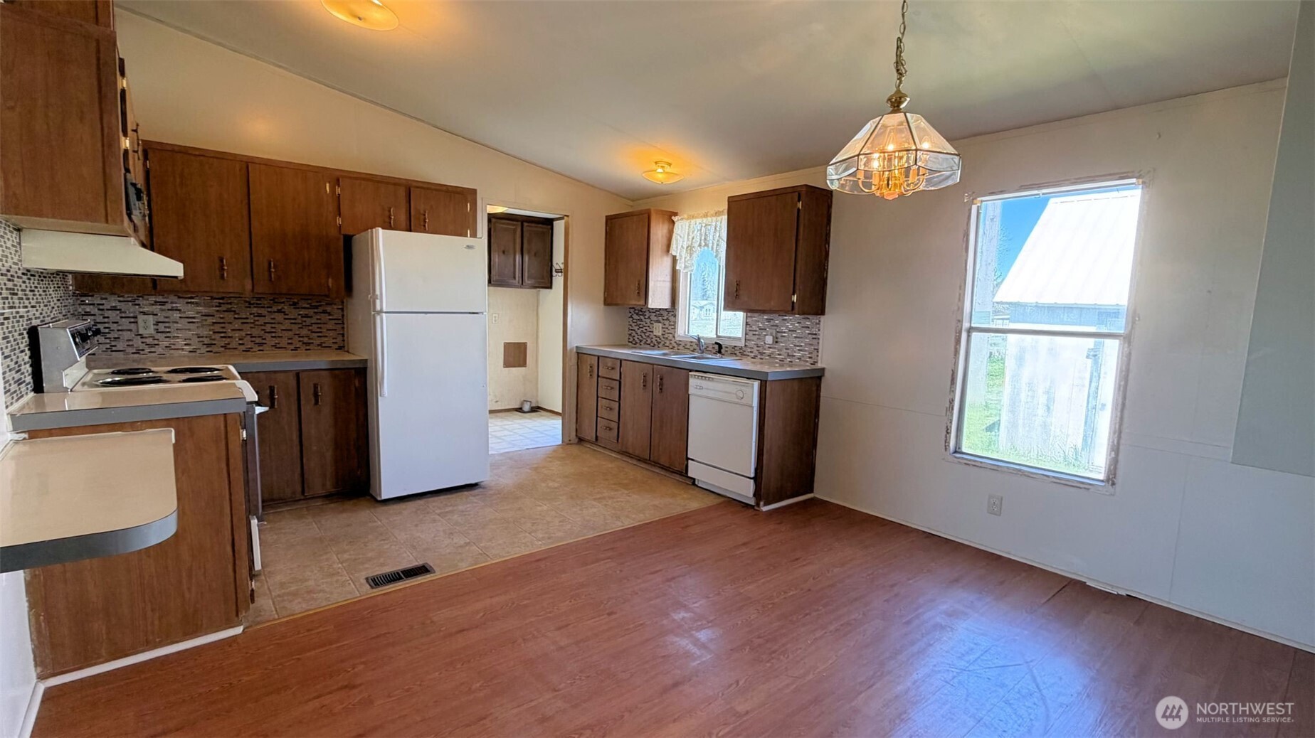 1210 2nd Street Davenport, WA 99122 - Photo 7 of 19 a view of kitchen with stainless steel appliances granite countertop cabinets and a wooden floor