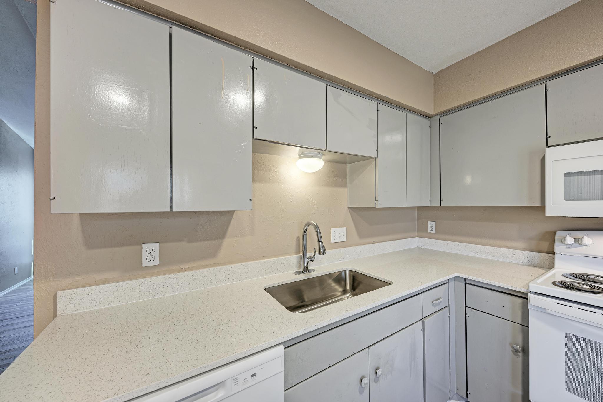 1117 West Rundberg Lane, Unit A Austin, TX 78758 - Photo 13 of 31 Kitchen with white appliances and light stone counters