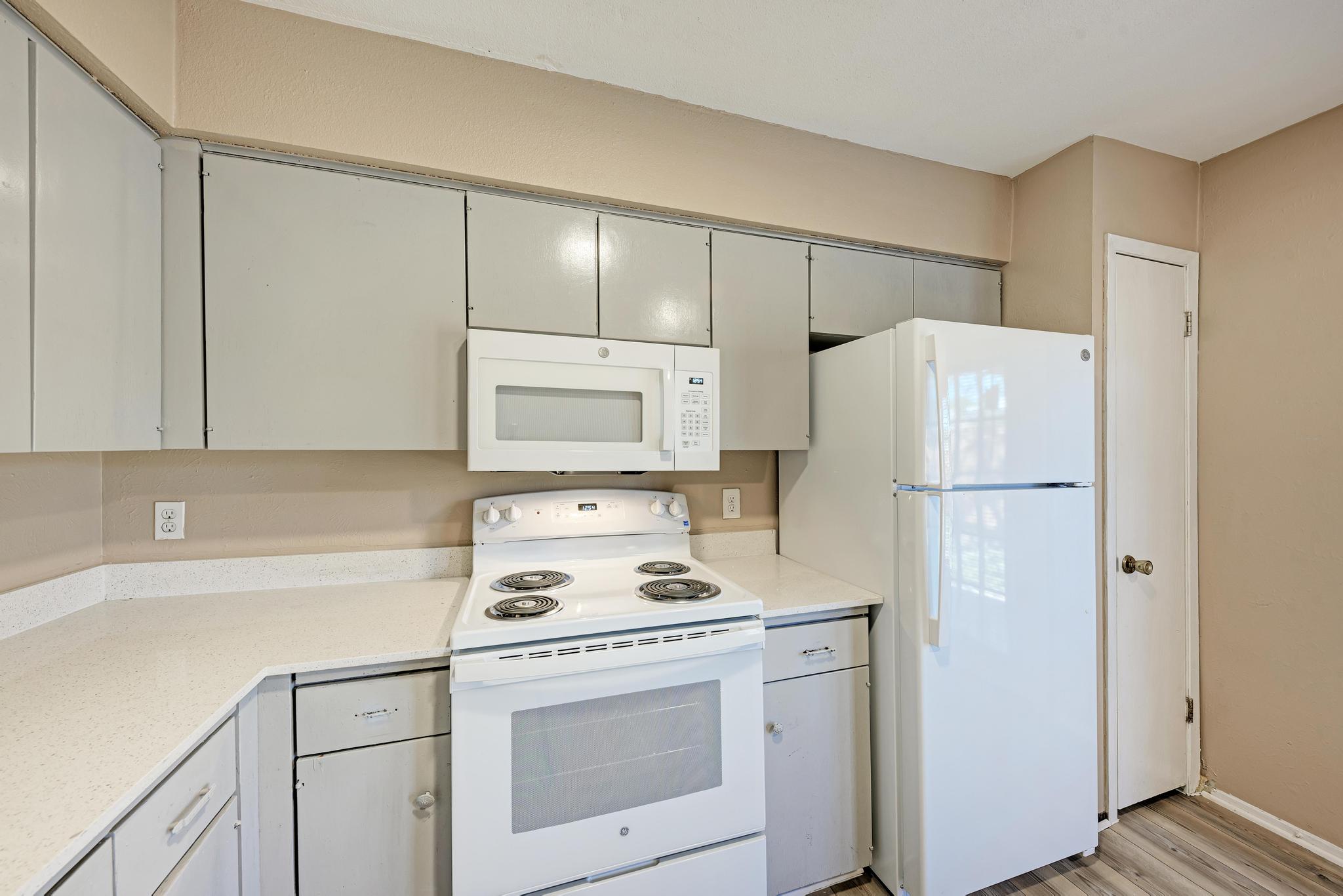 1117 West Rundberg Lane, Unit A Austin, TX 78758 - Photo 14 of 31 Kitchen featuring white appliances and light wood-style floors