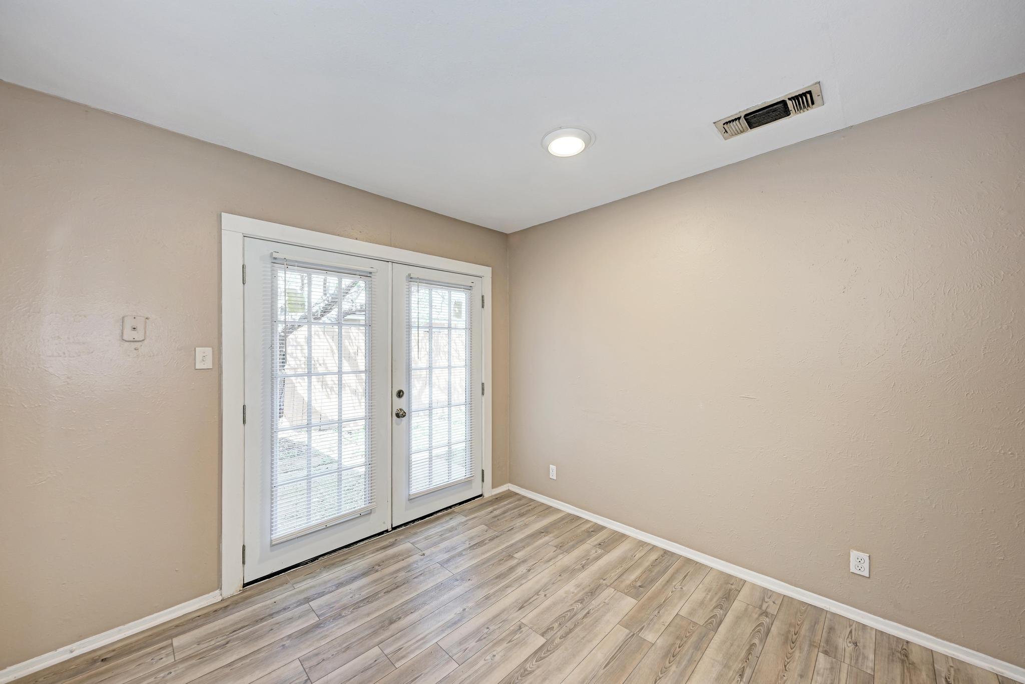 1117 West Rundberg Lane, Unit A Austin, TX 78758 - Photo 15 of 31 Entryway featuring french doors and wood finished floors