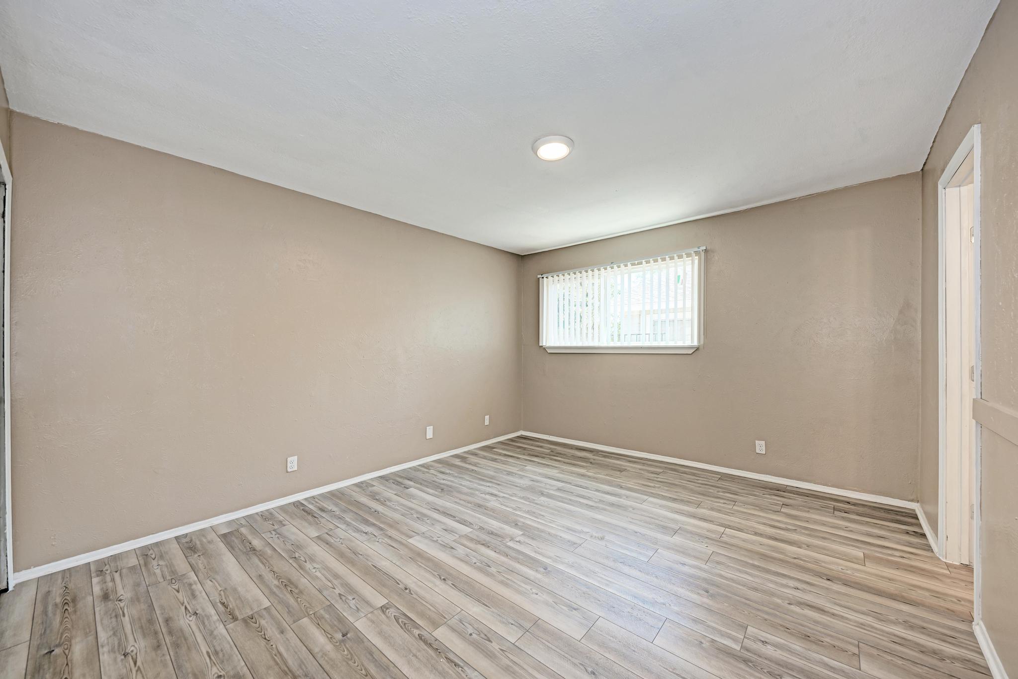1117 West Rundberg Lane, Unit A Austin, TX 78758 - Photo 16 of 31 Empty room featuring light wood-style floors and baseboards