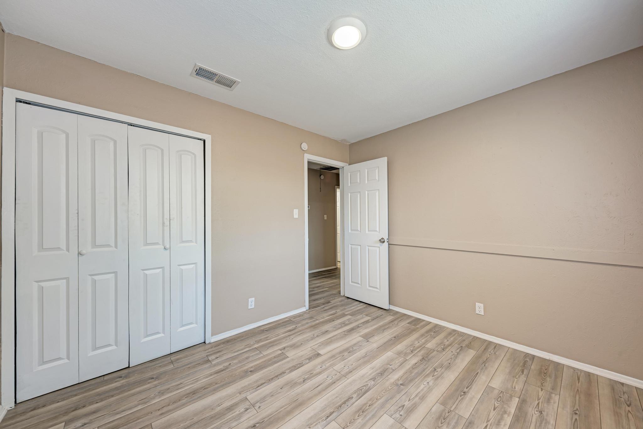 1117 West Rundberg Lane, Unit A Austin, TX 78758 - Photo 20 of 31 Unfurnished bedroom featuring light wood-type flooring and a closet