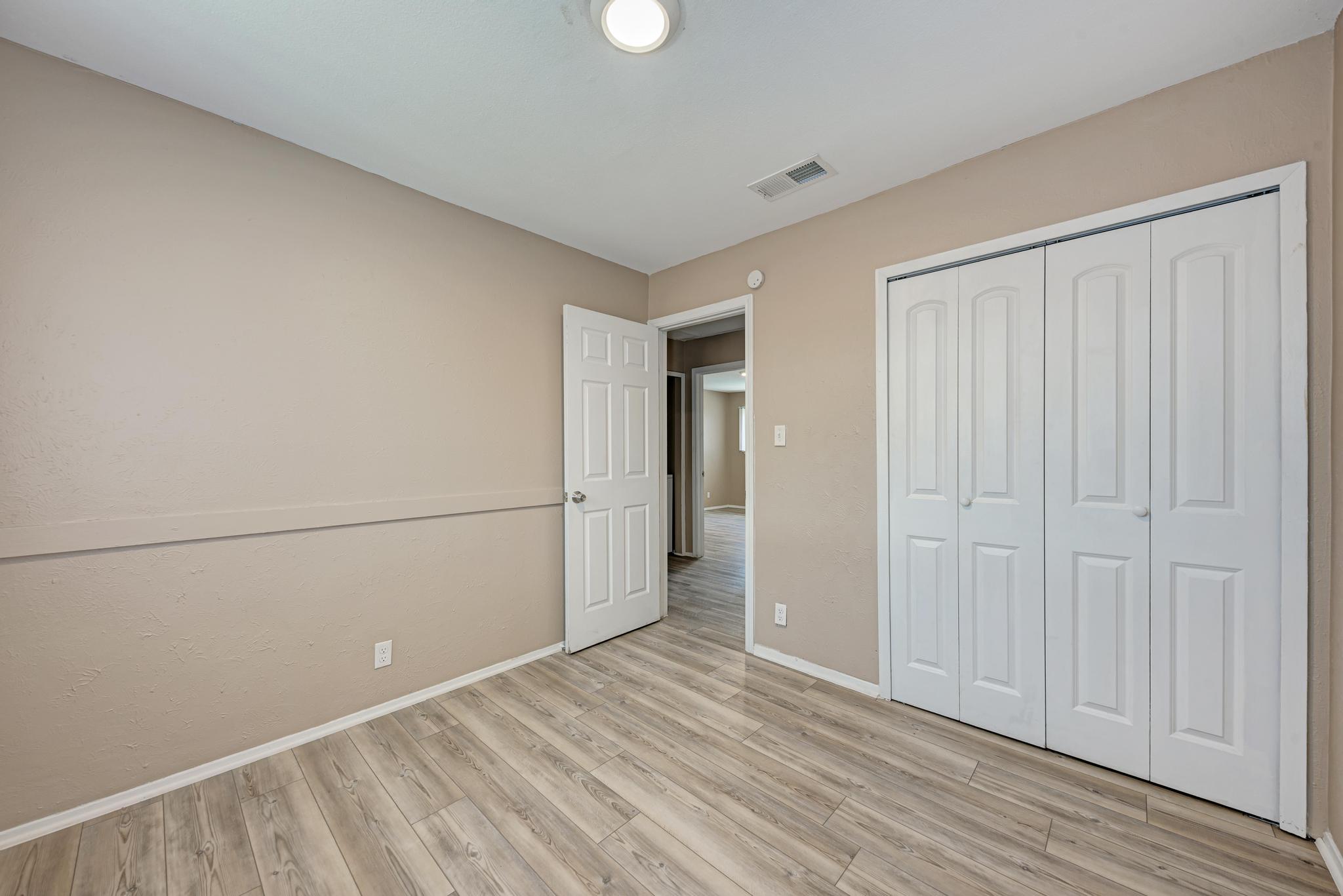 1117 West Rundberg Lane, Unit A Austin, TX 78758 - Photo 23 of 31 Unfurnished bedroom with light wood finished floors and a closet