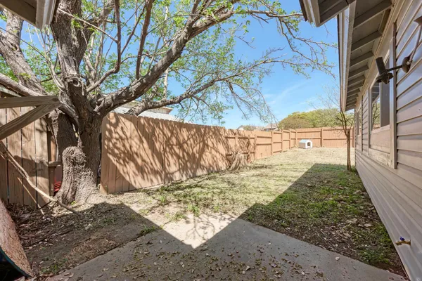 a view of a yard with a tree
