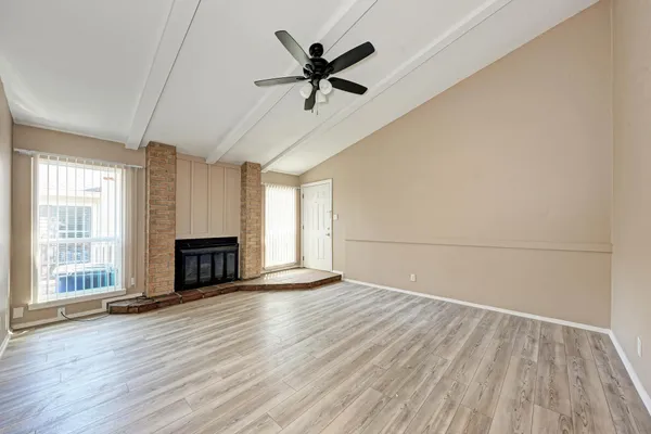 wooden floor in an empty room with a fireplace
