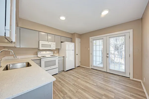 a kitchen with appliances cabinets and a sink