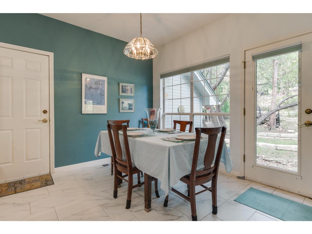 1602 Wild Basin Ledge Austin, TX 78746 - Photo 11 of 40 a view of a dining room with furniture wooden floor and chandelier