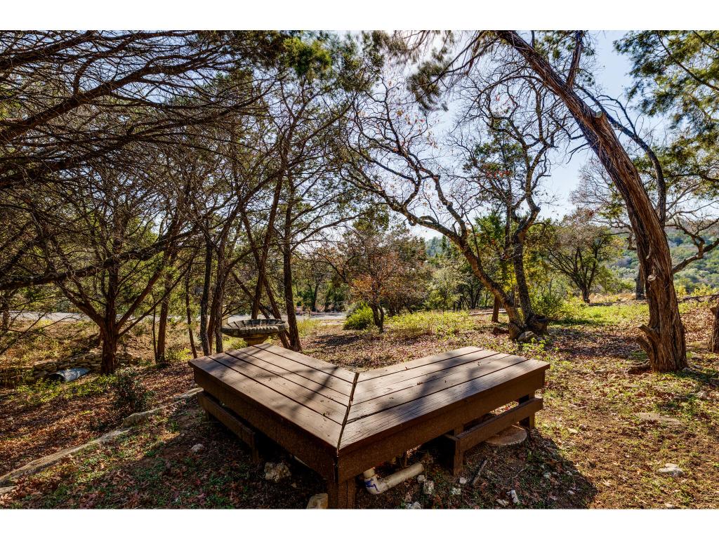 1602 Wild Basin Ledge Austin, TX 78746 - Photo 33 of 40 a backyard of a house with table and chairs