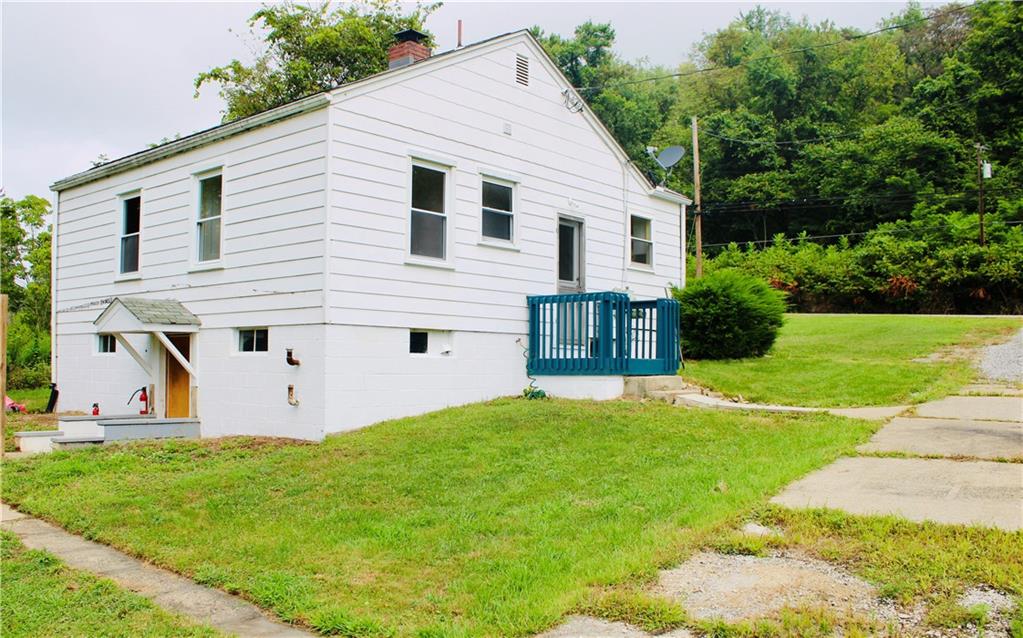 1248 Saltsburg Road Export, PA 15632 - Photo 36 of 44 a view of a white house with a yard plants and large tree