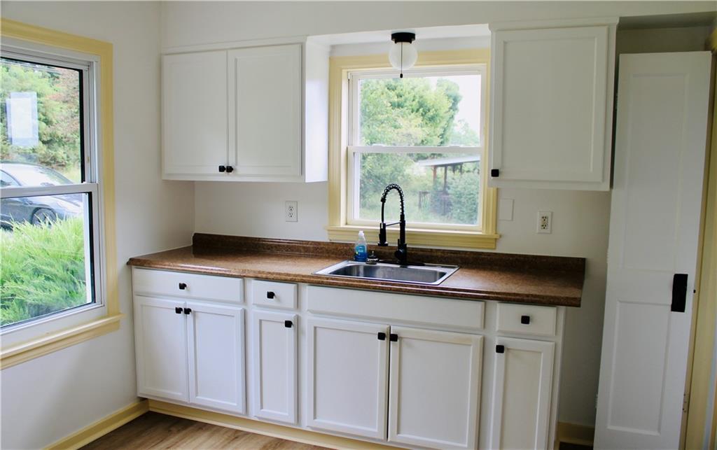 1248 Saltsburg Road Export, PA 15632 - Photo 7 of 44 a kitchen with stainless steel appliances white cabinets and a window