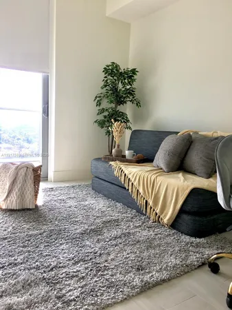 a bedroom with a bed lamp and a potted plant