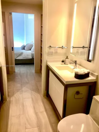 a bathroom with a sink toilet and mirror