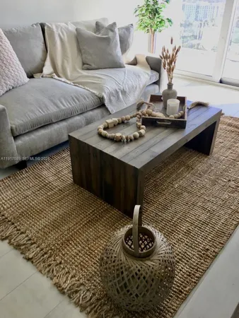 a living room with furniture and a rug