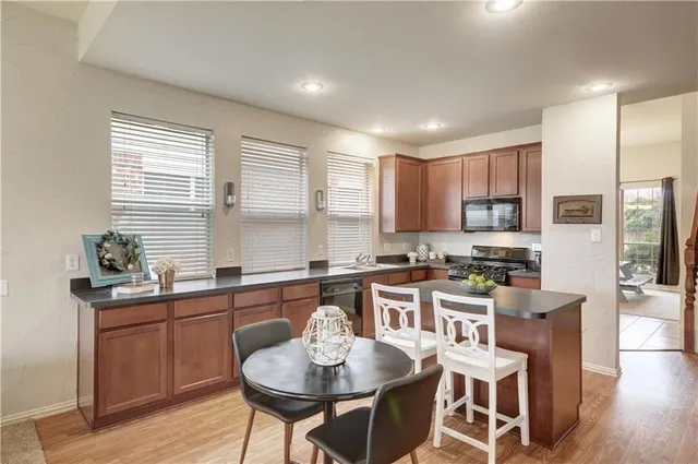 a kitchen with granite countertop a sink and cabinets