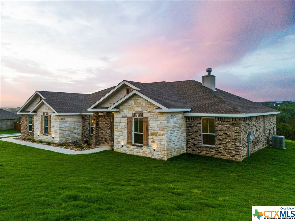 a front view of a house with a garden