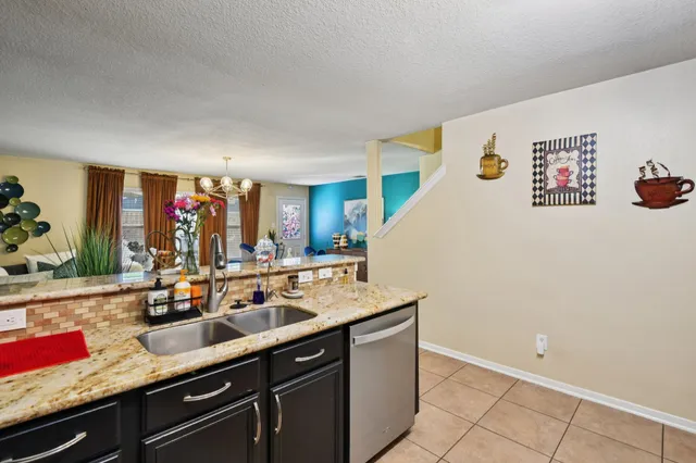 a kitchen with a sink and a refrigerator