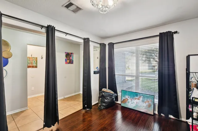 a view of a room with wooden floor and windows