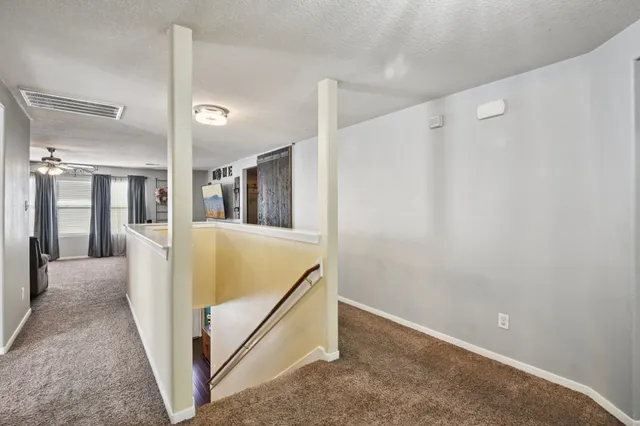 a view of hallway with bathroom