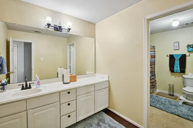a en suite bathroom with double sink and a mirror