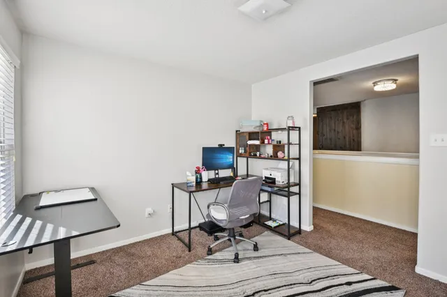 a work room with furniture and wooden floor