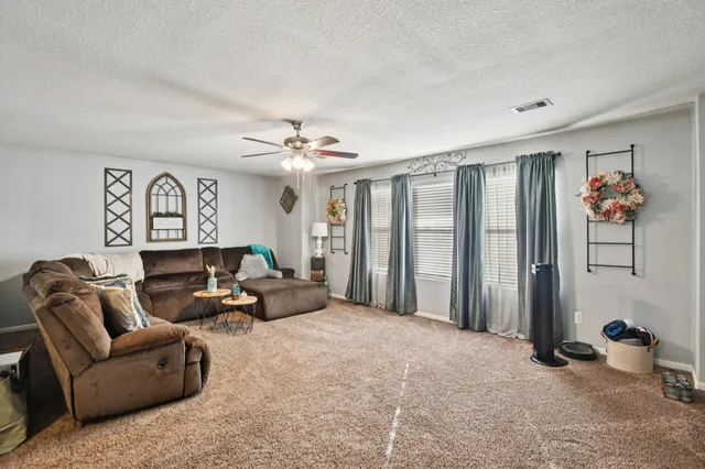 a living room with furniture and a chandelier