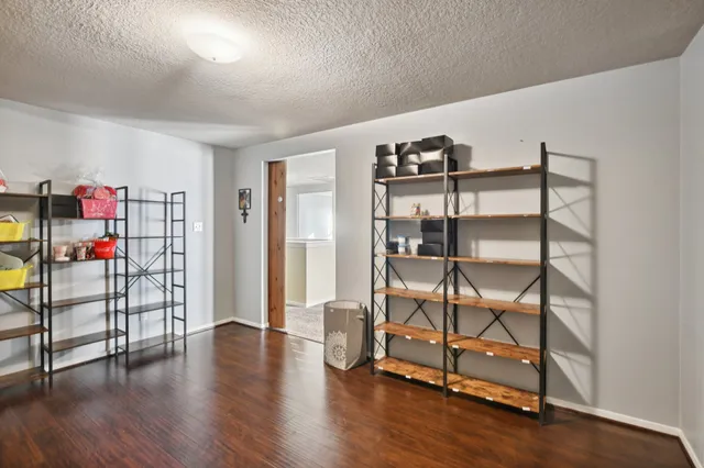 a view of a room with racks on the wall and a window