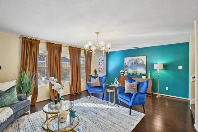 a living room with furniture and a chandelier