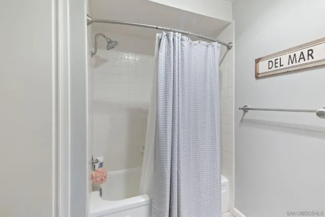 a bathroom with a shower and a tub