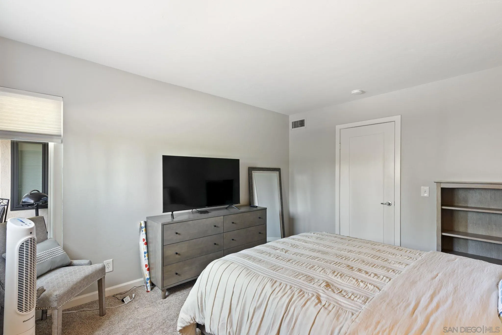 17617 Pomerado Road, Unit 112 San Diego, CA 92128 - Photo 13 of 26 a bedroom with a bed and a flat screen tv