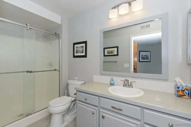 a bathroom with a sink toilet and shower
