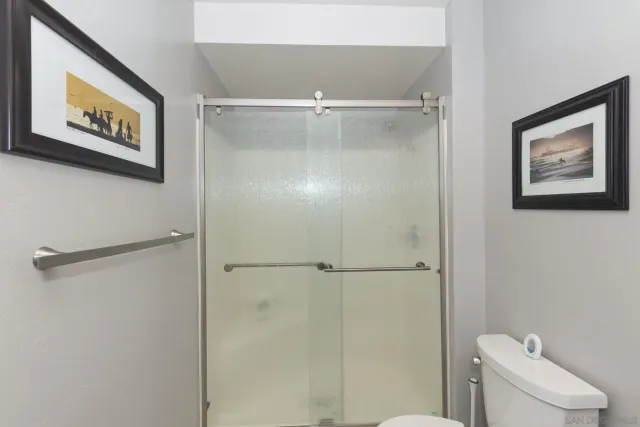a bathroom with a shower and a toilet in it