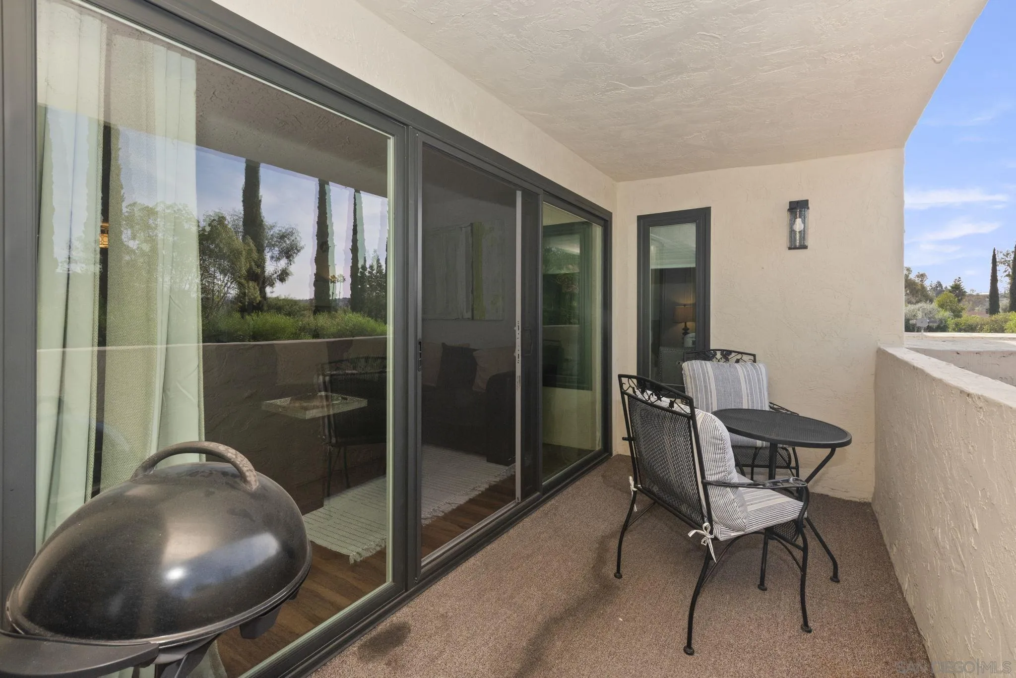 17617 Pomerado Road, Unit 112 San Diego, CA 92128 - Photo 18 of 26 a living room with furniture and a floor to ceiling window
