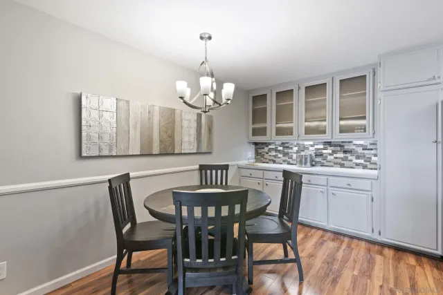 a view of a dining room with furniture wooden floor and chandelier