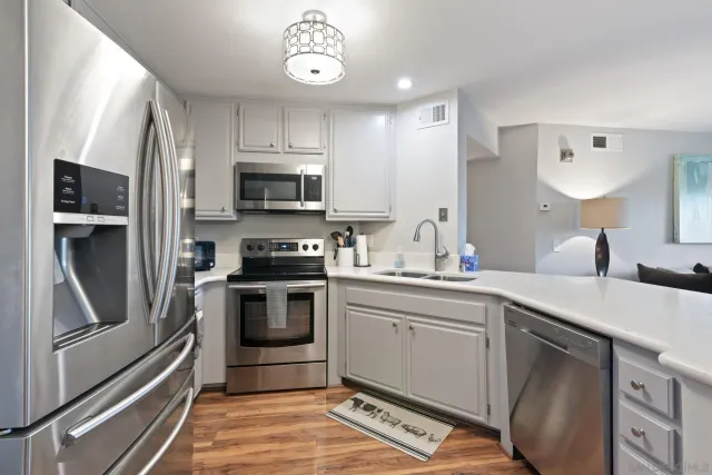 a kitchen with a sink cabinets and stainless steel appliances