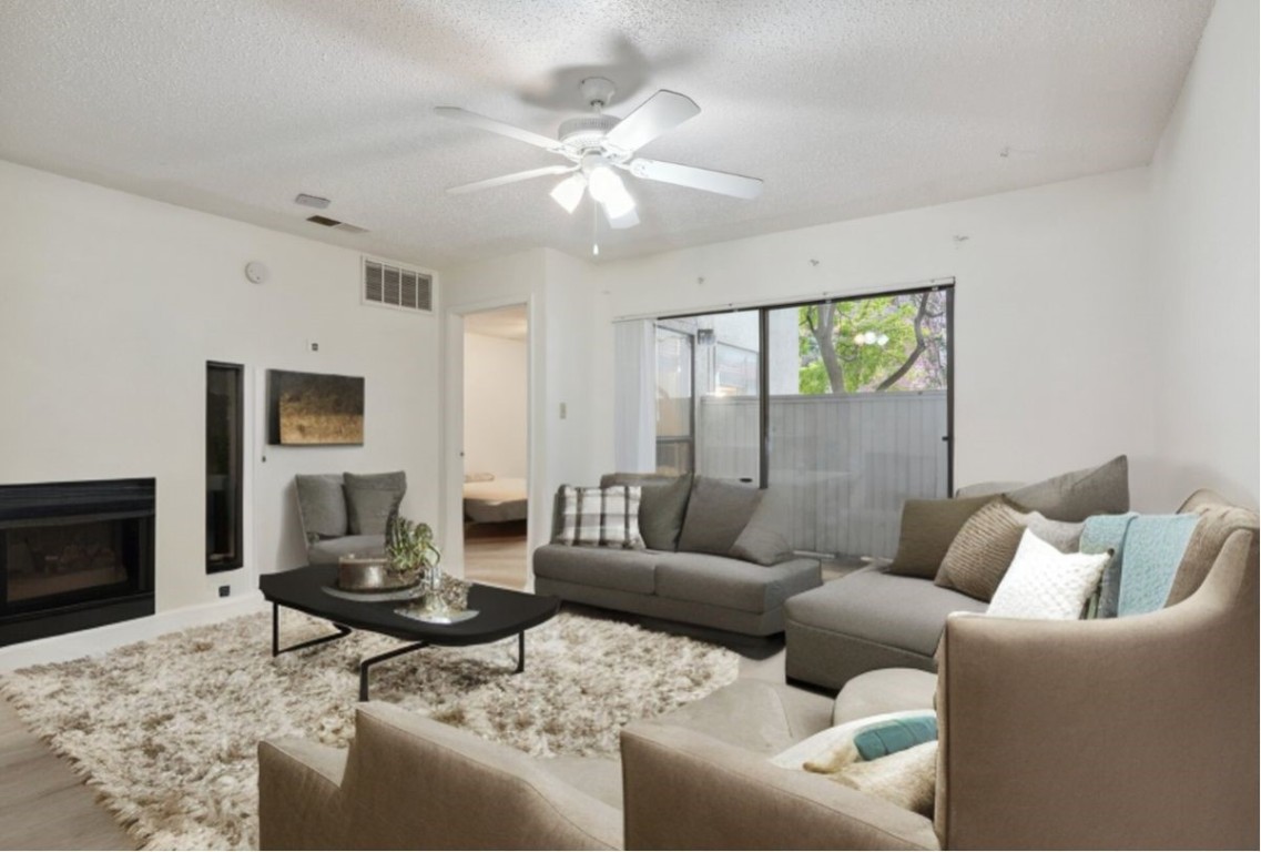 a living room with furniture and a fireplace