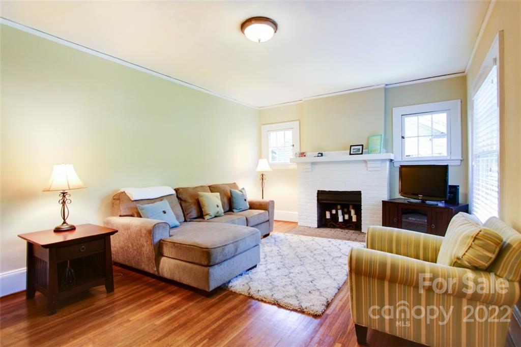 2123 Park Road Charlotte, NC 28203 - Photo 2 of 13 a living room with furniture a fireplace and a flat screen tv