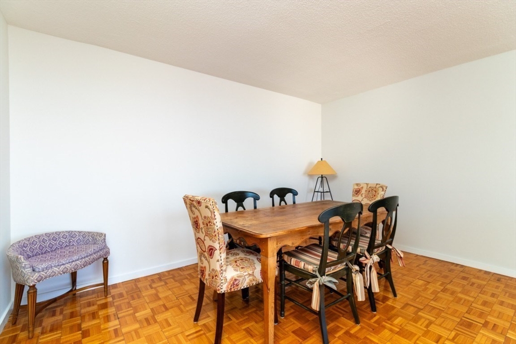 33 Pond Avenue, Unit 1106 Brookline, MA 02445 - Photo 13 of 32 a dining room with furniture and wooden floor